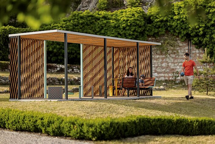 <div id="container" class="container">Pavillon CUBY MEET zum Aufdübeln bei +/- 0 mm, Dachbreite x Dachtiefe 6600 mm x 2200 mm, Dacheindeckung aus Holzlamellen, Wandelemente aus Holzspalier, Stahlkonstruktion in RAL 7016 anthrazitgrau und RAL 7035 lichtgrau, Sitzbänke und Drehsitz mit Jatobaholzbelattung sowie Tisch in RAL 1021 rapsgelb gegen Mehrpreis</div>